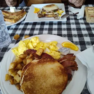 Wagon wheel breakfast with bacon and bolo.  Also sausage breakfast sandwich in e background