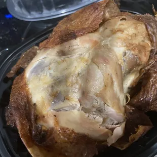 a roast chicken in a plastic container