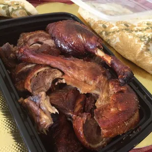 a tray of meat and bread on a table