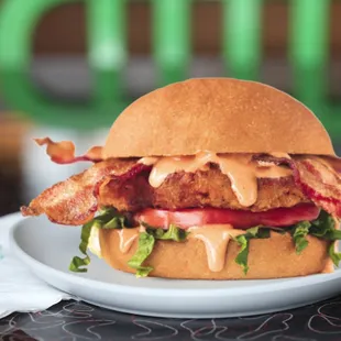 a chicken sandwich with bacon and lettuce