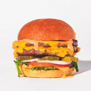 a hamburger with cheese and pickles