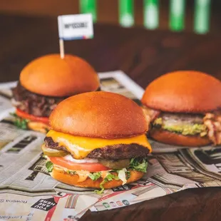 two hamburgers on a newspaper