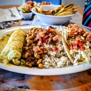 2 item plate: enchilada and taco with rice and beans
