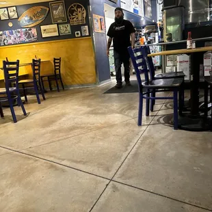 Employee bussing a table.