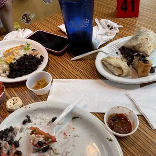 a plate of fish tacos with rice and beans