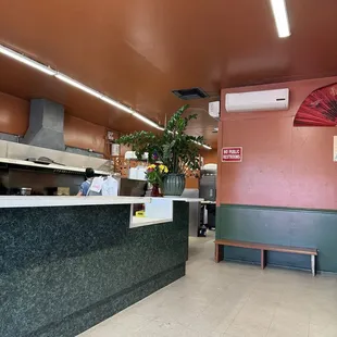 Spacious feel in waiting area. View past counter to open kitchen.