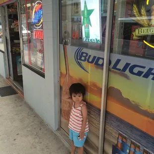 a little girl standing in front of a window