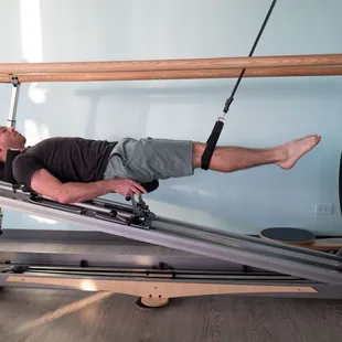 On the GYROTONIC Jumping-Stretching board honing in on proper alignment and mechanics for running and jumping.