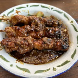 Sate Ayam - three char-broiled chicken skewers with peanut sauce and acar (cucumber, carrot and chili relish)