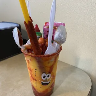 Mango smoothie with Mexican candy, spicy straw and chamoy