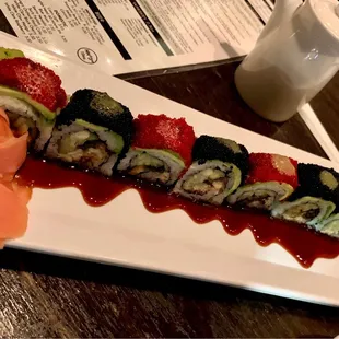 a plate of sushi with a variety of toppings
