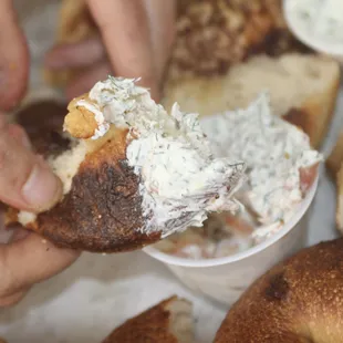 Plain Bagel ripped and dipped into Lox Cream Cheese