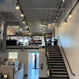 View of front area with additional seating and stairway to spacious upper area and seating