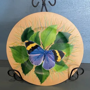 a butterfly painted on a plate