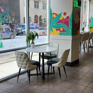 ows tables and chairs in front of large windows