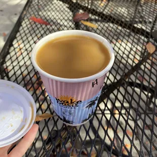 a hand holding a cup of coffee