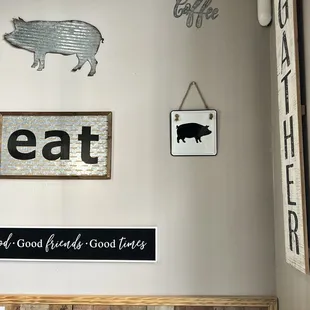a kitchen with a pig sign