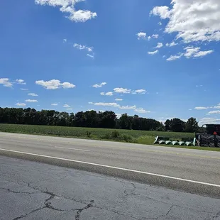 a tractor pulling a trailer down the road