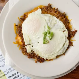 a plate of food with a fried egg on top