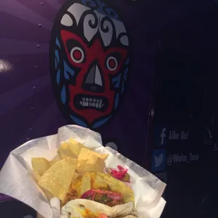 a hand holding a taco