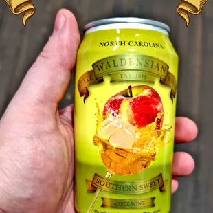 a hand holding a can