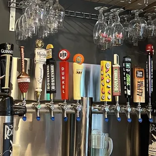 a variety of beer taps and glasses