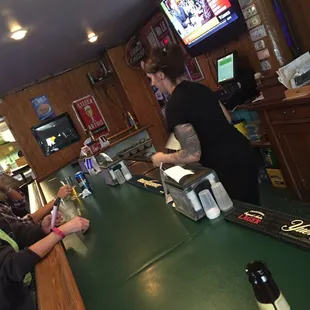 a bartender serving customers