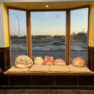 a window filled with stuffed animals