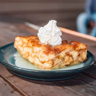 a piece of french toast with whipped cream