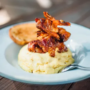 a plate of mashed grits and bacon