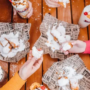 a group of people eating doughnuts