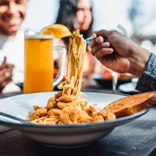 a plate of pasta being eaten with a fork