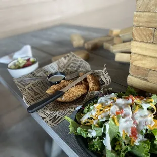 Kids chicken tenders with a side salad and fruit cup