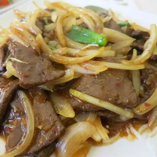 a plate of beef and onions