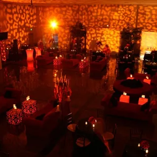 Light up cocktail tables, light up cubes and red sofas add the perfect touch.