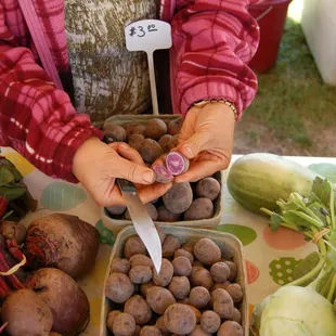 a woman cutting potatoes