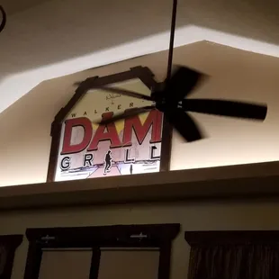 a ceiling fan and a sign