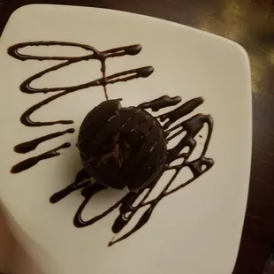 a chocolate covered donut on a plate