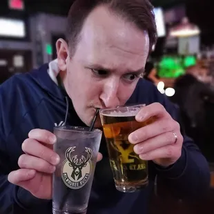 a man drinking a pint of beer