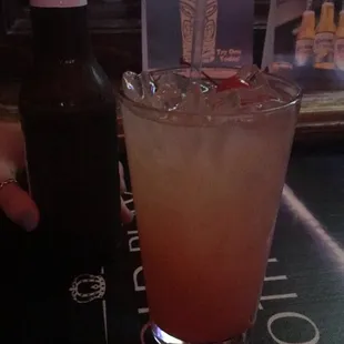 a drink and a bottle on a table