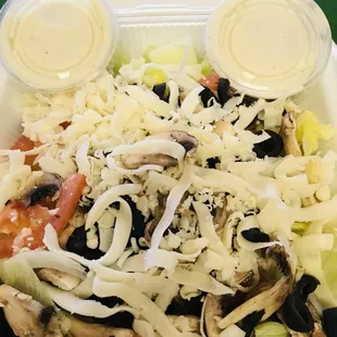 a salad in a styrofoam container