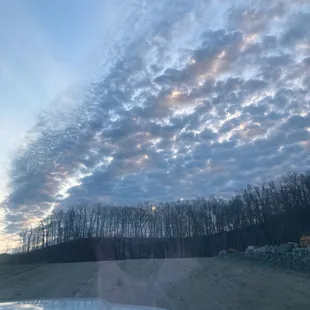 the view from the windshield of a car driving down a dirt road