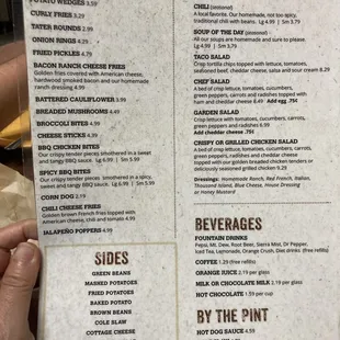 a hand holding a menu