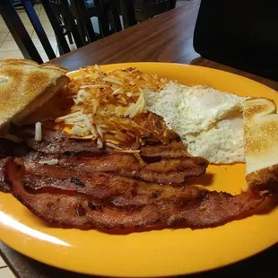 Eggs over easy, hash browns, crispy bacon.