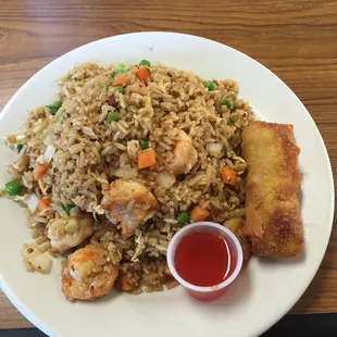 a plate of fried rice with shrimp and vegetables