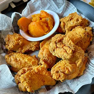 a plate of fried chicken and a bowl of dipping sauce