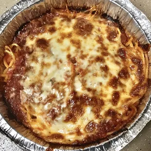 Spaghetti with Meat Sauce.  Love the crusty, gooey layer of meat sauce and cheese baked on top!