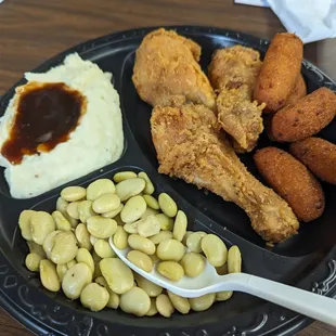 Fried chicken, lima beans, mashed potatoes and gravy, and hush puppies