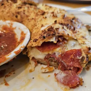 Pepperoni, sausage and bacon stromboli