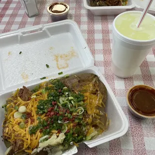 Texas size baked potato with all the fixings and brisket. BBQ sauce on the side, and a lite lemonade. YUM!!